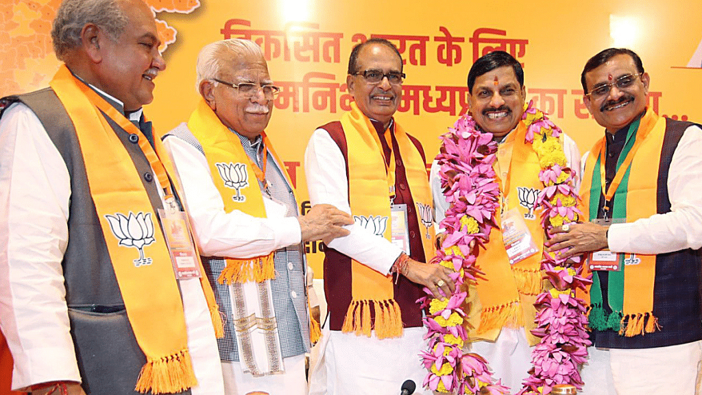 BJP three-time MLA Mohan Yadav (in garland) is congratulated by outgoing MP chief minister Shivraj Singh Chouhan and other senior leaders at party headquarters in Bhopal on Monday | ANI
