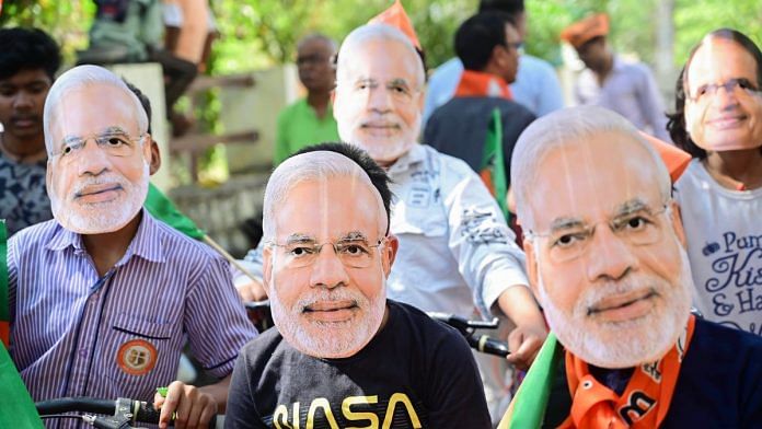 Supporters of Modi wear masks of the PM during an election campaign | Representational image | ANI