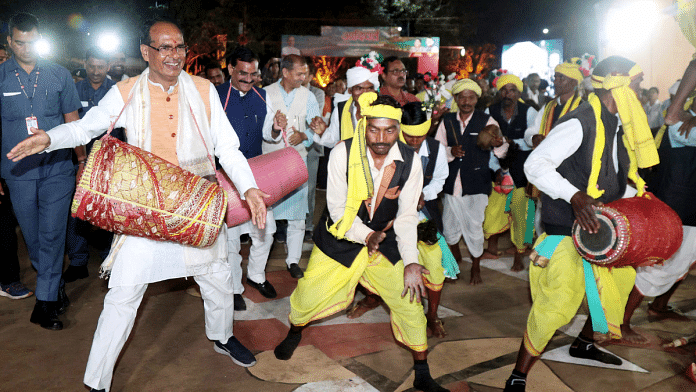 File photo of MP CM Shivraj Singh Chouhan with tribal artists during the first Culture Working Group meeting of G20 at Khajuraho I ANI