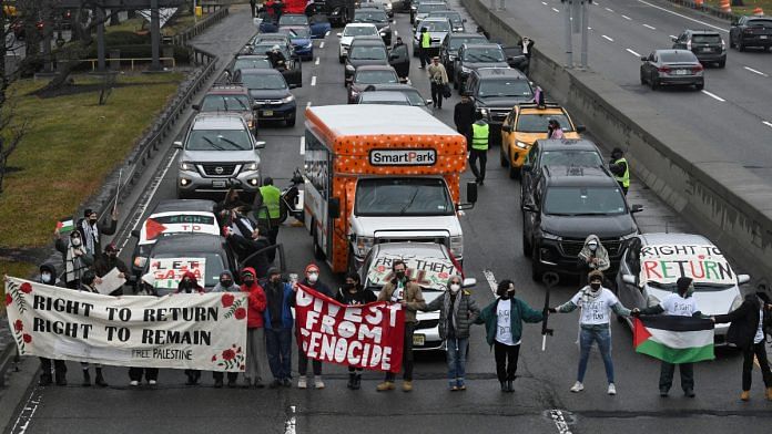 Pro-Palestinian demonstrators block traffic on the road that leads to John F Kennedy airport (JFK), amid the ongoing conflict between Israel and the Palestinian Islamist group Hamas, in New York City, U.S., December 27, 2023 | Reuters