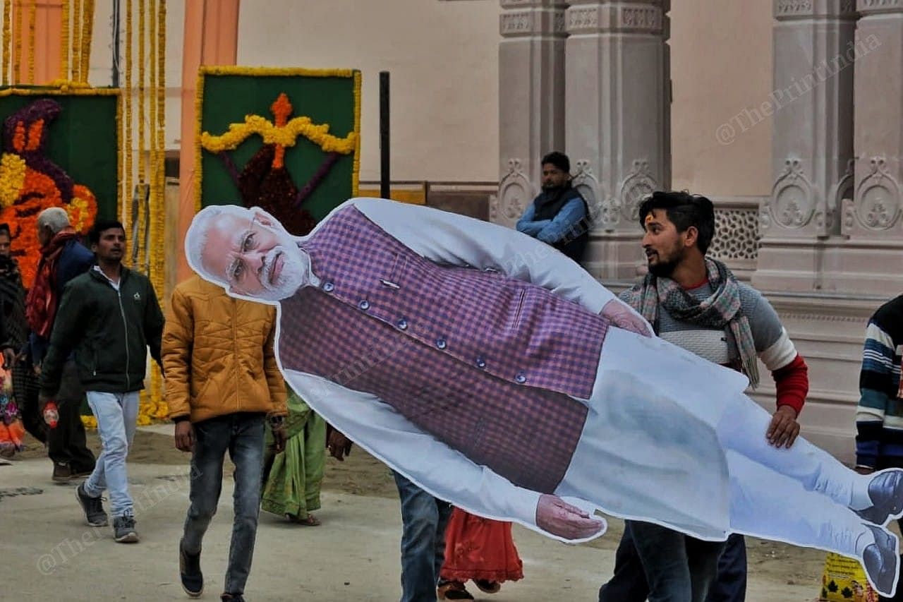 Man carrying PM Modi hoarding after the roadshow | Praveen Jain | ThePrint 