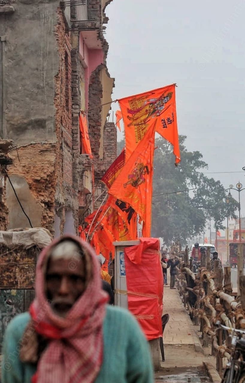Saffron flag of Lord Ram flutters against remnants of non descript, dilapidated structure in Babu Bazar as the temple town of Ayodhya undergoes an overhaul. | Praveen Jain | ThePrint 