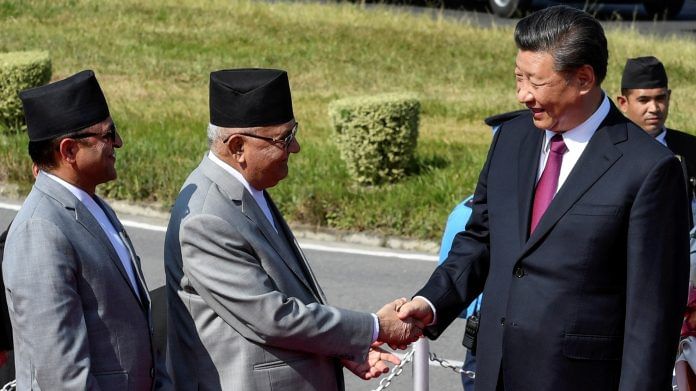 FILE PHOTO: China's President Xi shakes hands with Nepal's PM Oli in Kathmandu