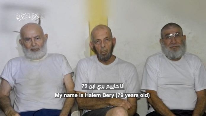 Three Israeli hostages appear in footage by Palestinian Islamist group Hamas at a location given as Gaza, in this still image obtained from handout video released December 18, 2023. Hamas Military Wing/Handout via Reuters