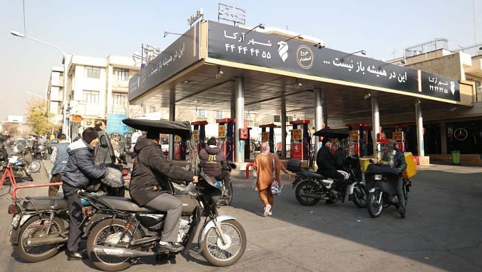 People wait at a gas station during gas station disruption in Tehran, on 18 Dec 2023 | West Asia News Agency via Reuters