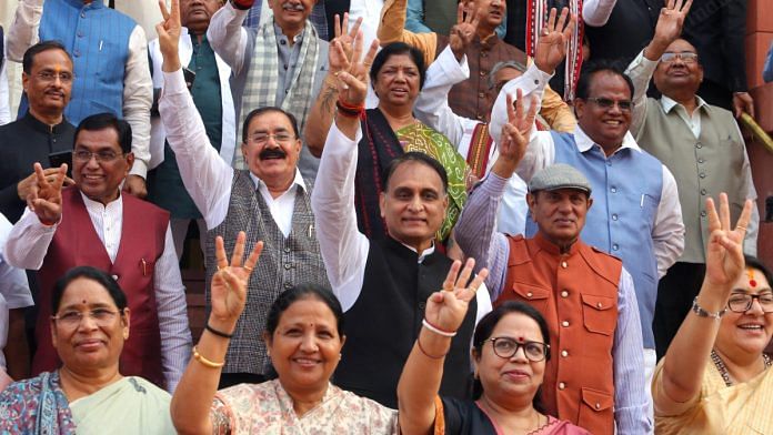 BJP MPs celebrate their party's victories in Rajasthan, Madhya Pradesh and Chhattisgarh, outside Parliament on the first day of winter session | Praveen Jain | ThePrint