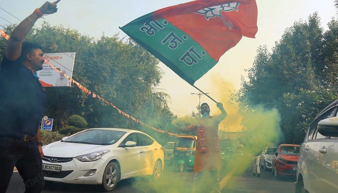 A BJP supporter celebrates after the party's victory in Madhya Pradesh, Rajasthan and Chhattisgarh | Suraj Singh Bisht | ThePrint