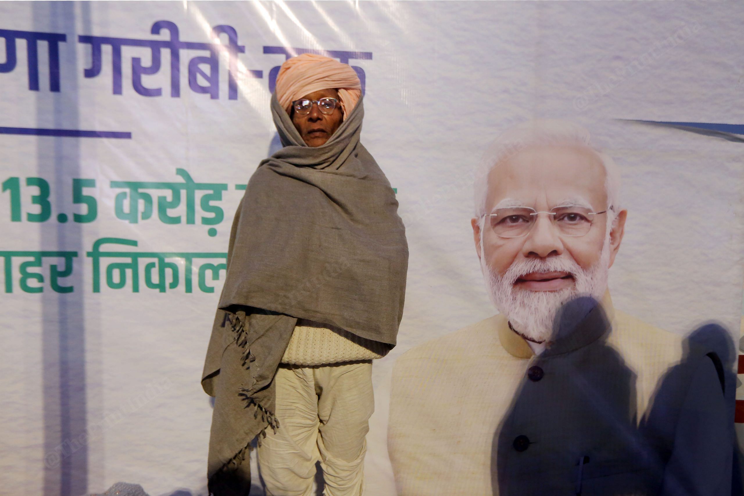 Devotee from Rajasthan standing in front of PM Modi's hoarding in Ayodhya | Praveen Jain | ThePrint