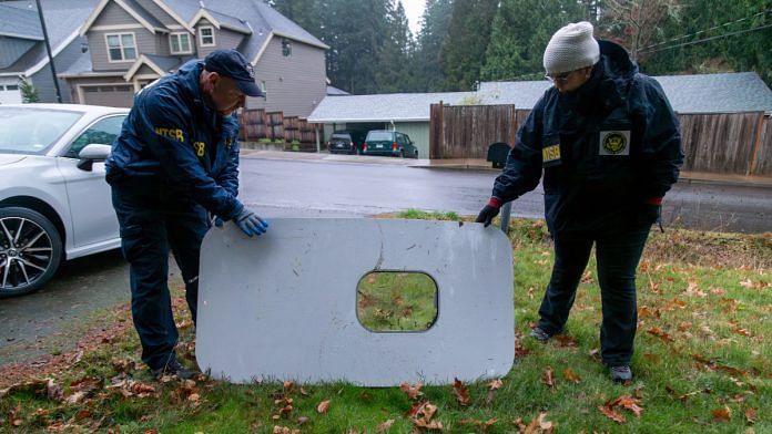 National Transportation Safety Board (NTSB) investigators examine the fuselage plug area of Alaska Airlines Flight 1282 Boeing 737-9 MAX, which was jettisoned and forced the aircraft to make an emergency landing, at a property where it was recovered in Portland, Oregon, U.S. January 8, 2024. NTSB/Handout via REUTERS.