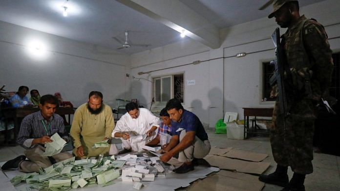 Election officials count votes after polling stations closed during the general election in Karachi | Reuters file photo