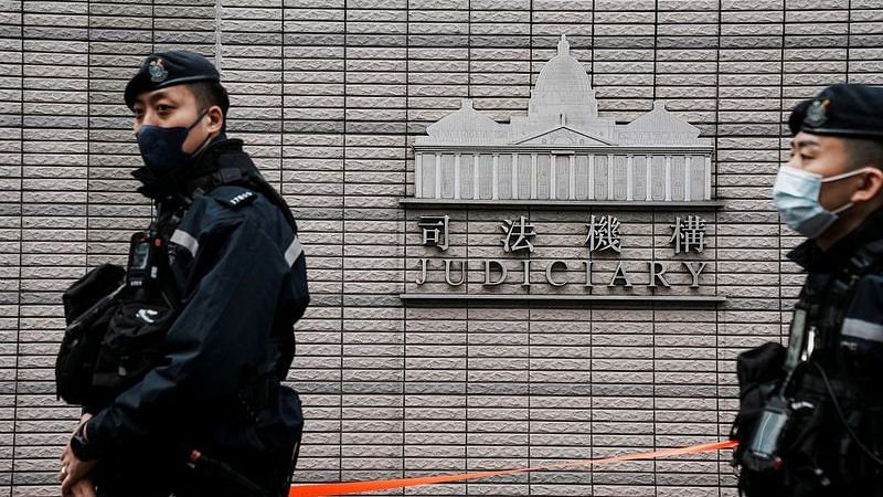 Police officers stand guard outside the West Kowloon Magistrates' Courts during the national security trial of media mogul Jimmy Lai, founder of Apple Daily, in Hong Kong, China December 18, 2023. REUTERS/Lam Yik/File Photo