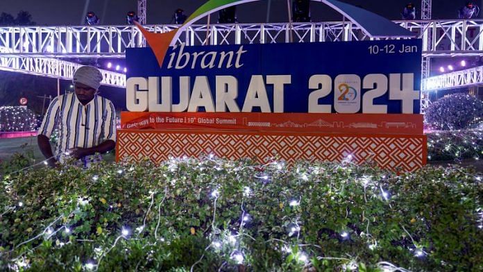 An electrician sets up lamps on a plant in front of Vibrant Gujarat Global Summit, in Ahmedabad, India, January 4, 2024. REUTERS/Amit Dave