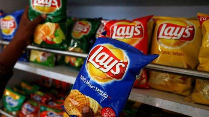 A customer picks packets of Lay's potato chips at a shop in Ahmedabad, India, April 26, 2019. REUTERS/Amit Dave/File Photo