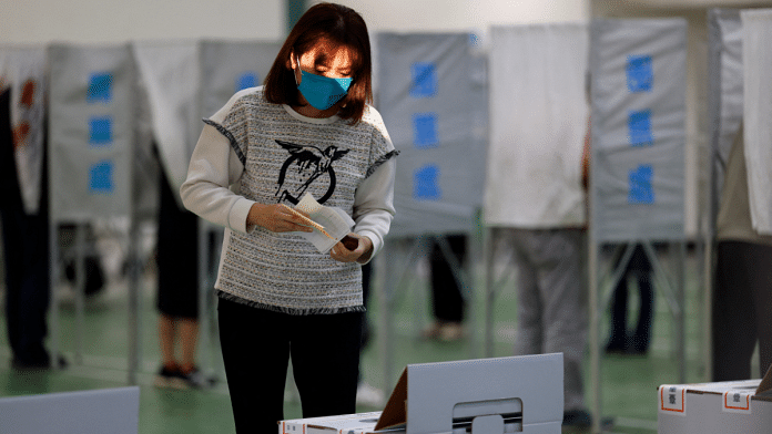 A woman prepares to cast her ballot at a polling station during the presidential and parliamentary elections in Tainan, Taiwan Saturday| Reuters/Ann Wang