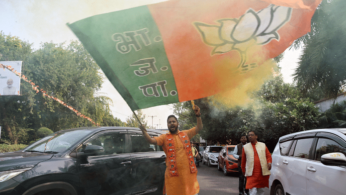 Representational photo of a BJP supporter waving the party flag during celebrations after its recent win in Madhya Pradesh, Rajasthan, and Chhattisgarh Assembly elections | ANI