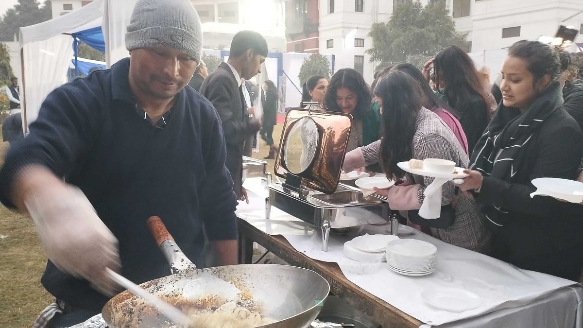 Flavors come alive at The Nepal Cookbook launch as attendees gather around the momos stall. Photo: Heena Fatima | ThePrint