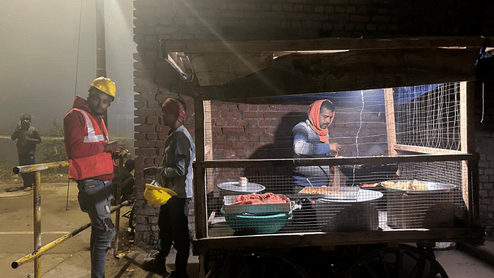 Tribhuvan Sharma (wearing safety helmet) at a roadside food stall in Ayodhya | Urjita Bhardwaj | ThePrint