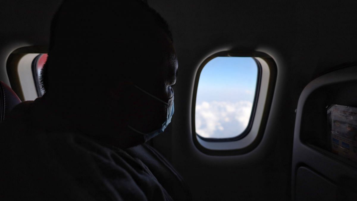 Andrew looks out of the window inside the plane | Photo: Manisha Mondal | ThPrint
