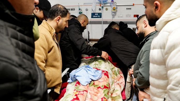 Mourners next to the body of a Palestinian killed following an Israeli raid in a hospital in Jenin in the Israeli-occupied West Bank, on 30 Jan 2024 | Reuters