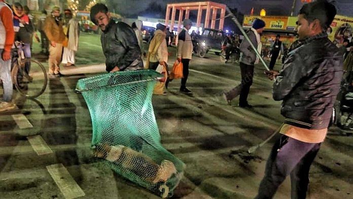 Workers of Municipal Corporation Ayodhya catching stray dogs at the main Lata Mangeshkar Chowk | Praveen Jain | ThePrint