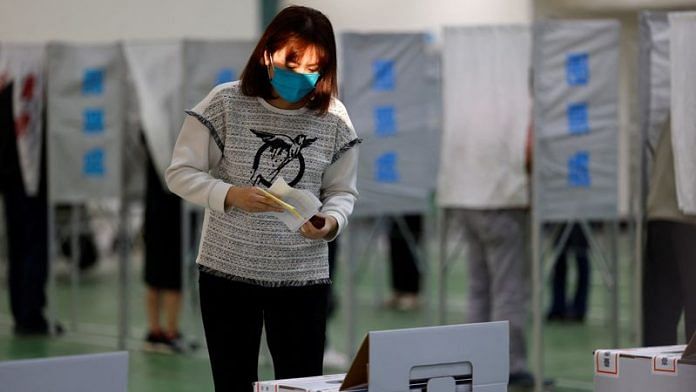 A woman prepares to cast her ballot at a polling station during the presidential and parliamentary elections in Tainan, Taiwan January 13, 2024. REUTERS/Ann Wang