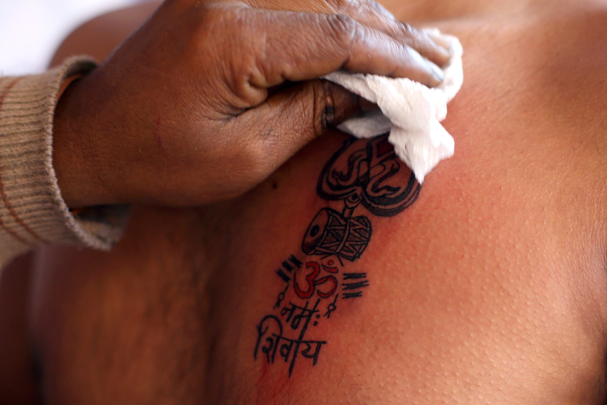 A devotee gets a tattoo on his chest | Photo: Suraj Singh Bisht | ThePrint
