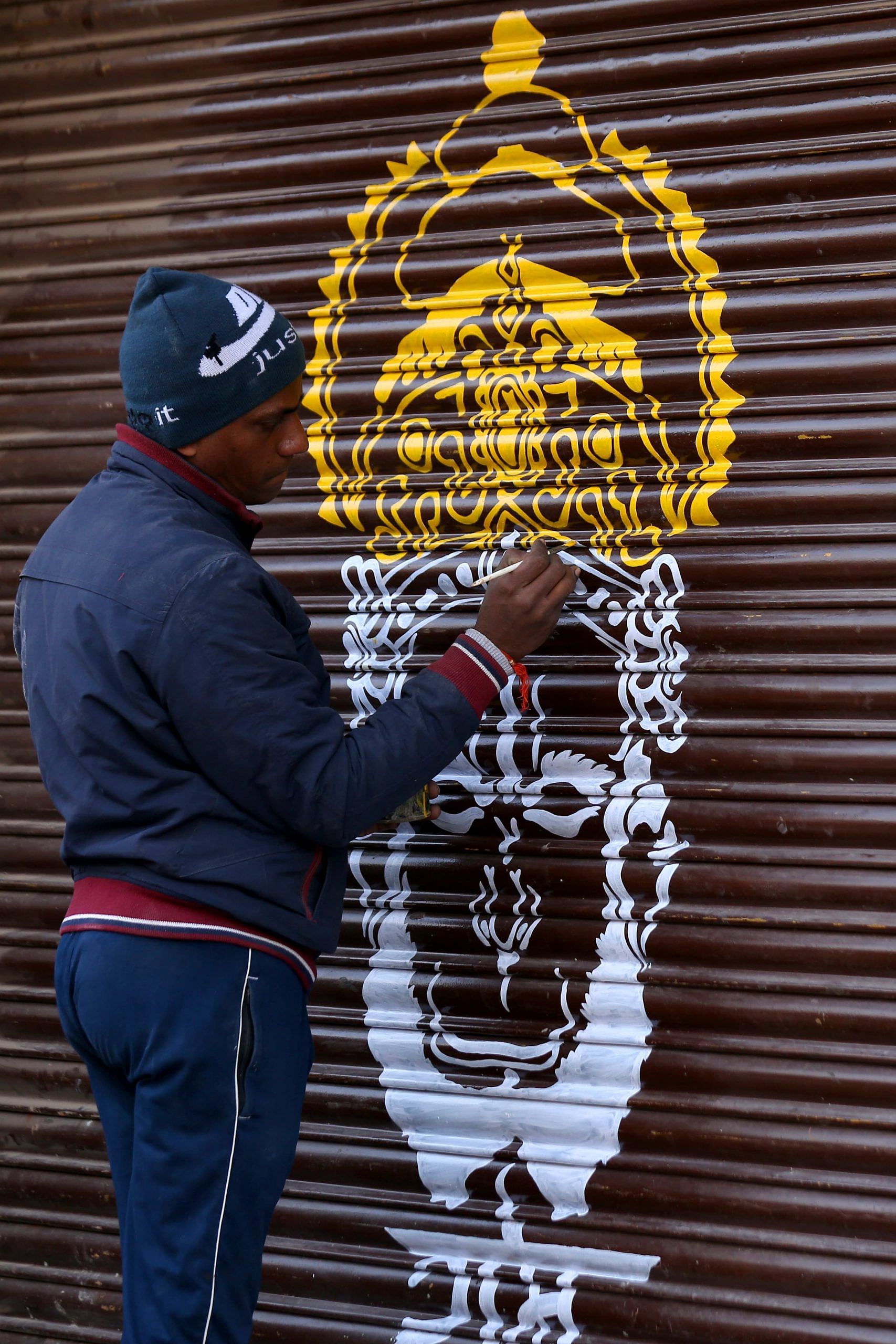 Ram is the first and last word in Ayodhya. Here an artist paints an image of the deity on the shutters of a shop near the Ram temple in Ayodhya | Photo: Suraj Singh Bisht | ThePrint