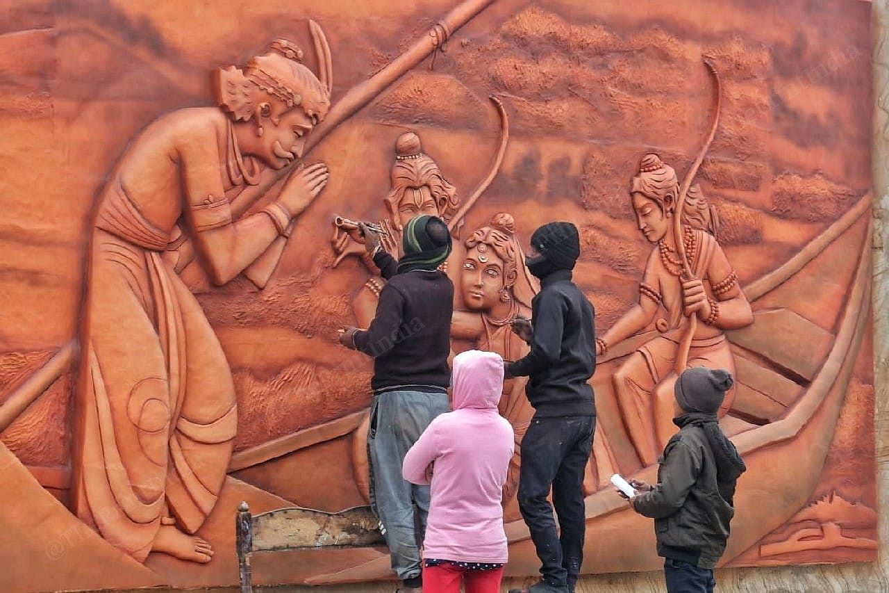 Artists give finishing touches to a wall art | Photo: Praveen Jain | ThePrint