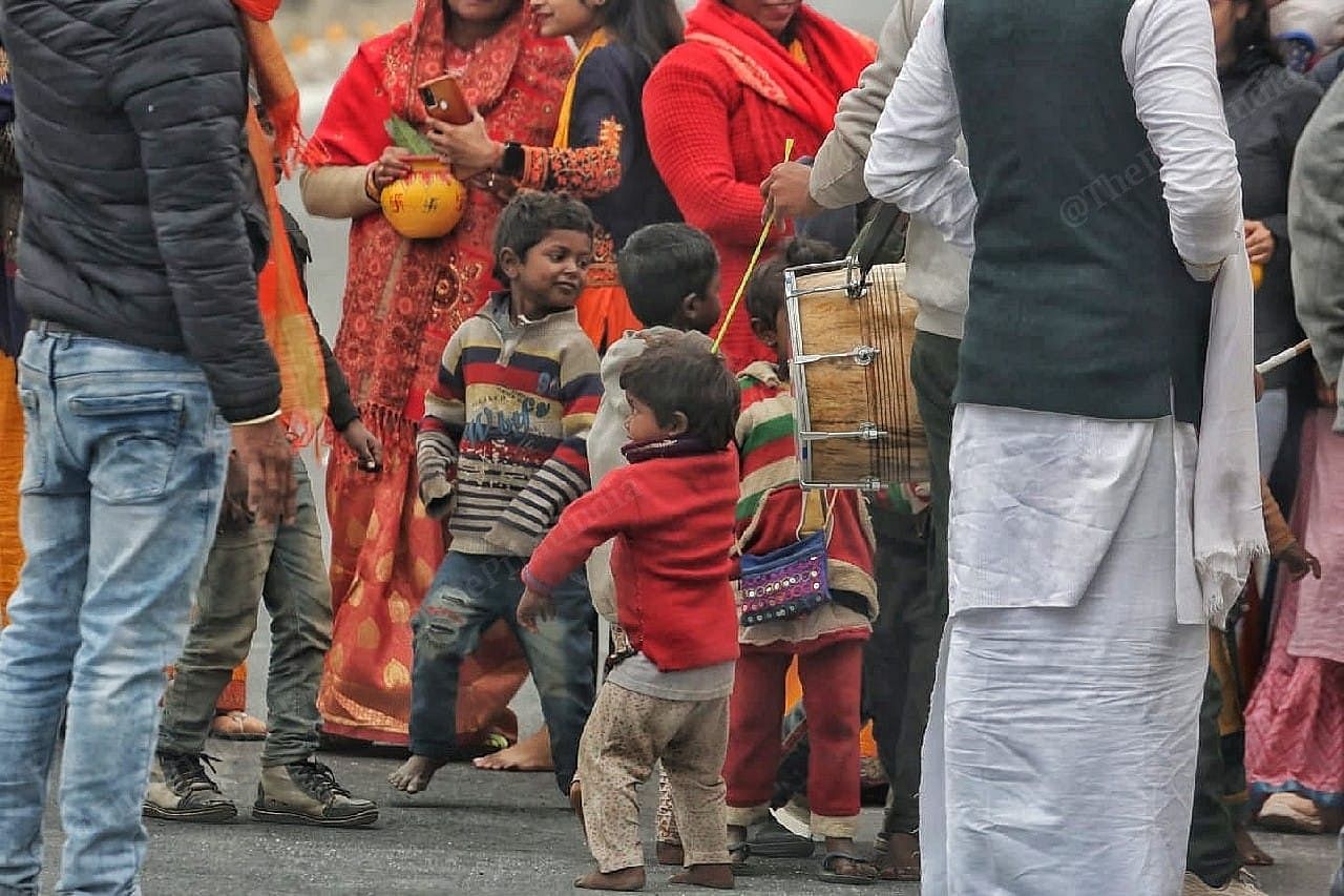 Children break into a dance as a group of devotees, attended by drums and music, make their way towards the Ram temple | Photo: Praveen Jain | ThePrint