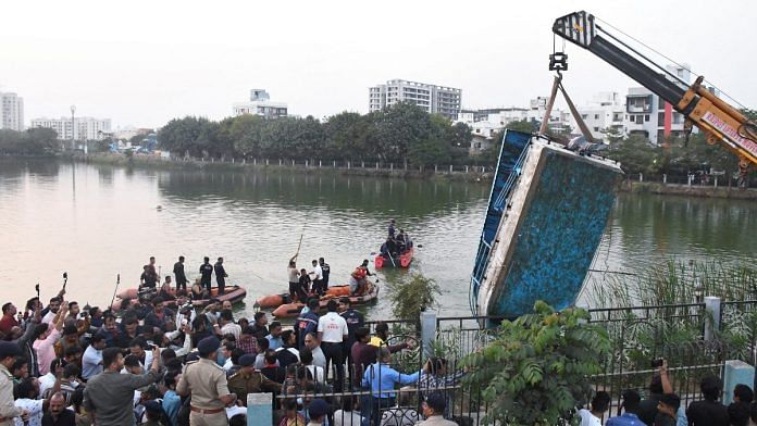 A crane pulls out the boat which capsized in Harni Lake carrying children and teachers who were on a picnic, in Vadodara, on 18 Jan 2024 | Reuters