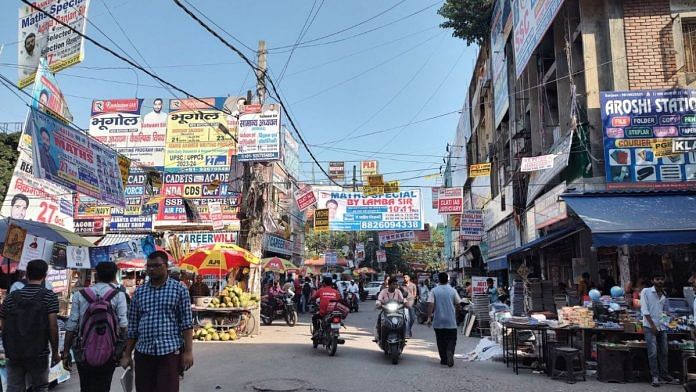 File photo of one of the busy bylanes in Mukherjee Nagar, Delhi, decorated with banners of coaching classes of UPSC and other competitive exams | Photo: Nidhima Taneja | ThePrint