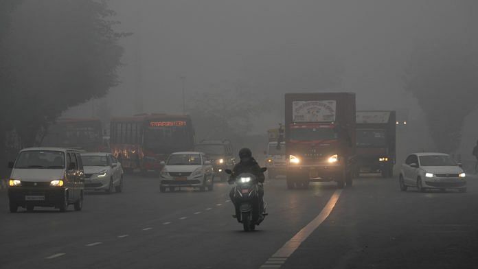 Vehicles ply on road amid low visibility during fog on a cold winter morning, in New Delhi, Sunday, Jan. 14, 2024. A blinding layer of fog shrouded the Indo-Gangetic plains in North India on Sunday, with visibility levels plunging to zero metres at several places | PTI