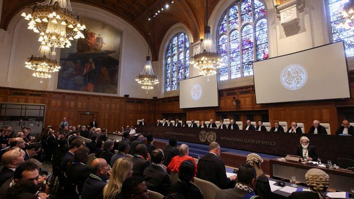 People sit inside the International Court of Justice (ICJ) on the day of the trial to hear a request for emergency measures by South Africa, who asked the court to order Israel to stop its military actions in Gaza and to desist from what South Africa says are genocidal acts committed against Palestinians during the war with Hamas in Gaza, in The Hague, Netherlands, January 11, 2024 | Reuters