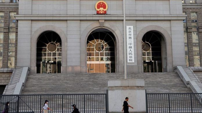 People walk past one of the entrances of Beijing No. 2 Intermediate People's Court where Australian writer Yang Hengjun is expected to face trial on espionage charges | Reuters file photo