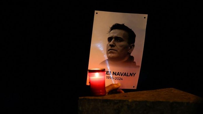 A person holds a portrait of Russian opposition leader Alexei Navalny as people attend a protest and vigil held in front of the Russian embassy following the death of Navalny, in Kappara, Malta, February 19, 2024. REUTERS/Darrin Zammit Lupi/File Photo