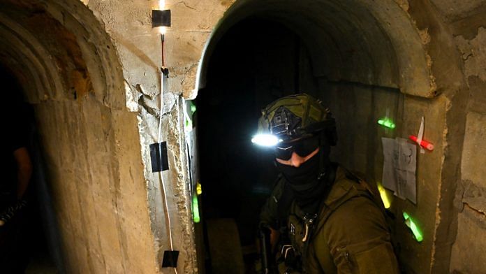 An Israeli soldier standing in 'Hamas command tunnel' running partly under UNRWA HQ in Gaza on 8 Feb 2024 | REUTERS/Dylan Martinez