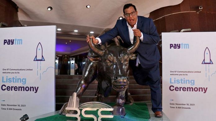 Paytm founder and CEO Vijay Shekhar Sharma poses with a bronze replica of a bull after the company's IPO listing ceremony at the BSE in Mumbai | Reuters file photo