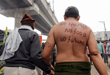 A farmer has slogans written on his back at Tikri Border in New Delhi | ANI