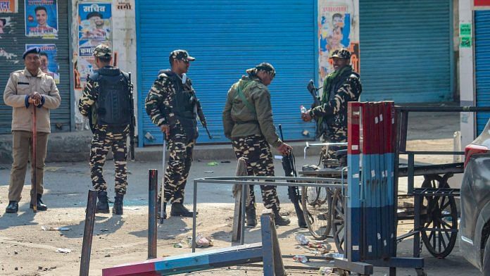 Security personnel stand guard during curfew at Banbhoolpura area that witnessed arson and vandalism by a mob over the demolition of an allegedly illegally-built madrasa on Thursday, in Haldwani, Saturday, Feb. 10, 2024 | PTI