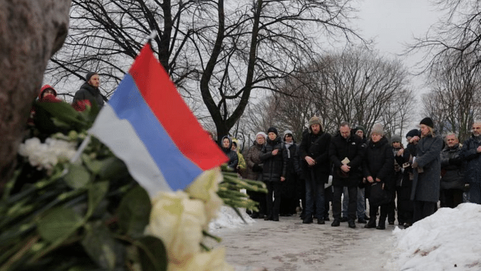 People gather at the Solovetsky Stone monument to the victims of political repressions to honour the memory of Russian opposition leader Alexei Navalny, in Saint Petersburg, Russia February 17, 2024 | Reuters