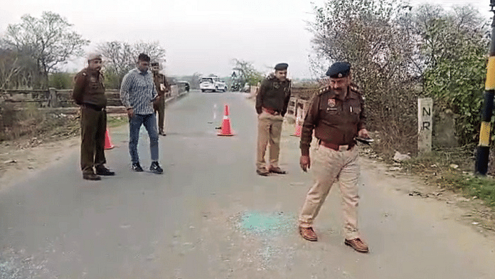 Police personnel inspect the site after Haryana INLD chief Nafe Singh Rathee was shot dead by unidentified assailants, at Bahadurgarh in Jhajjar on Sunday. | ANI