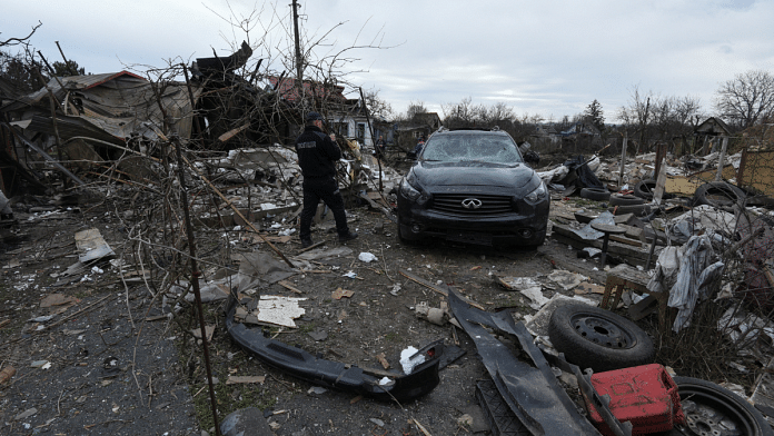 A police officer inspects a residential area heavily damaged during a Russian missile and drone strike, amid Russia's attack on Ukraine, in the city of Kamianske, Dnipropetrovsk region, Ukraine, March 29, 2024 | Reuters/Mykola Synelnykov