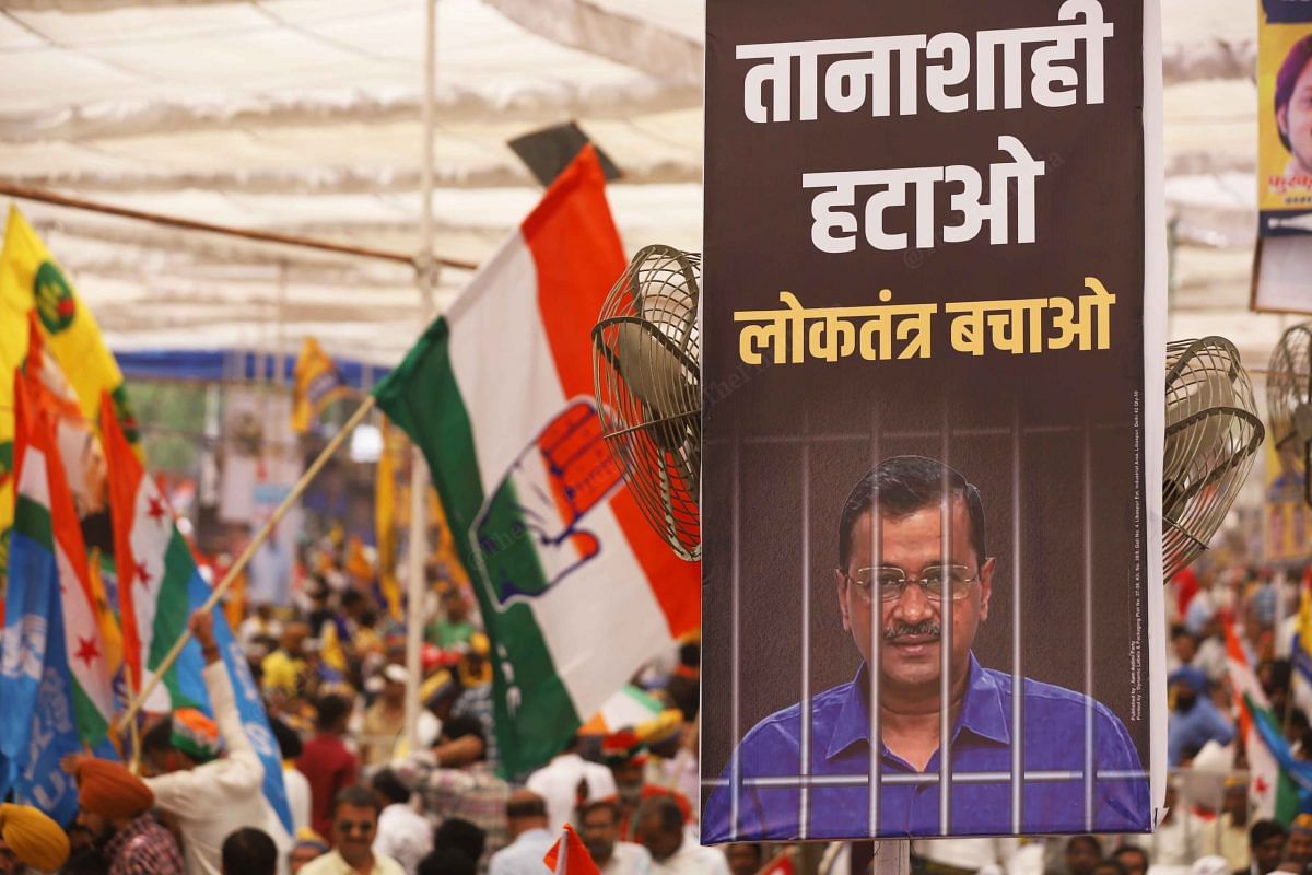 Kejriwal hoarding with the Congress flags in the backdrop | Photo: Manisha Mondal | ThePrint