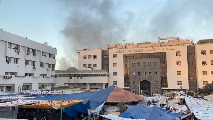 Smoke rises as displaced Palestinians take shelter at Al Shifa hospital, amid the ongoing conflict between Hamas and Israel, in Gaza City, November 8, 2023 | Reuters