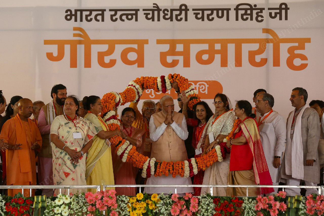Prime Minister Narendra Modi being garlanded during an election campaign rally | Photo Suraj Singh Bisht, ThePrint