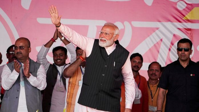 Prime Minister Narendra Modi waves to supporters during a rally at Arambagh, in Hooghly district, Friday, March 1, 2024. (PTI Photo/Swapan Mahapatra