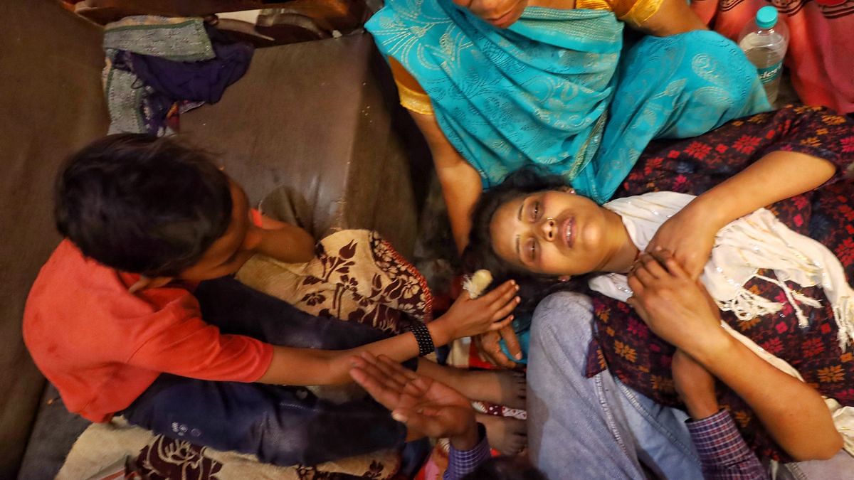 Piyush, the son who managed to escape, comforts his mother. | Manisha Mondal | ThePrint