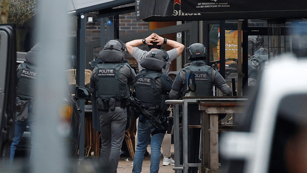 Police officers detain a person near the Cafe Petticoat, where several people were being held hostage in Ede, Netherlands, March 30, 2024 | Reuters/Piroschka Van De Wouw