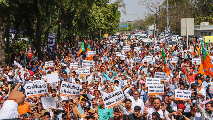 BJP workers demand resignation of Delhi CM Arvind Kejriwal over his arrest by the ED in connection with an excise policy-linked money-laundering case, in New Delhi, Tuesday on 26th March | PTI