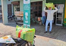 Farmer Balwinder Singh carries a bag of granular urea to his motorcycle, purchased from the Pradhan Mantri Kisan Samriddhi Kendra in Karnal, Haryana | TCA Sharad Raghavan | ThePrint